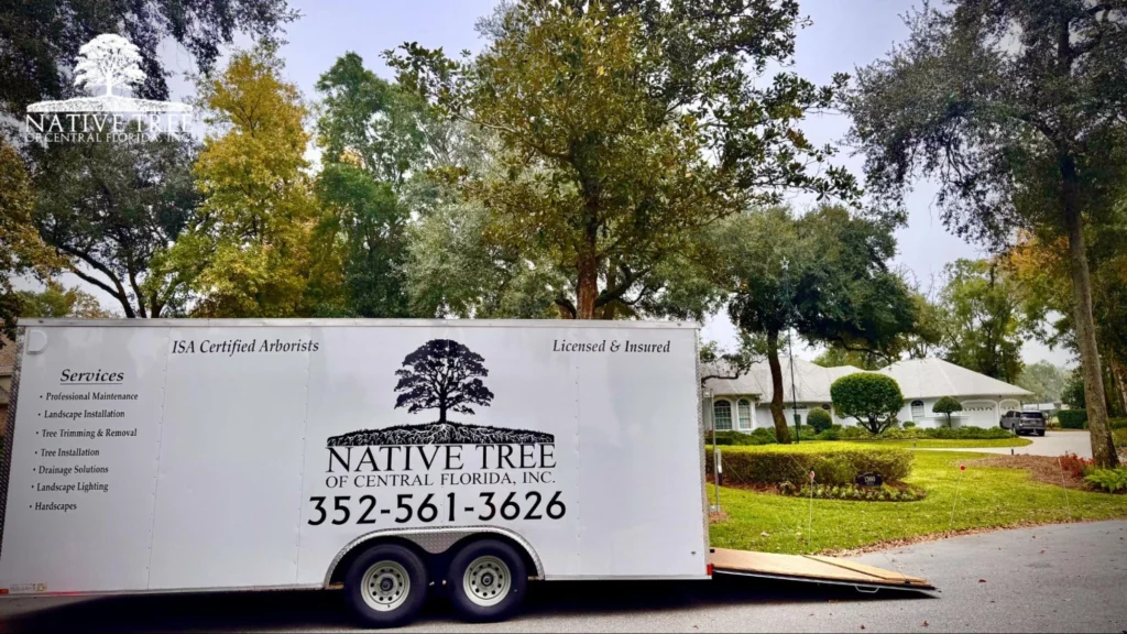 A white trailer branded with a native tree logo, used for supporting tree care operations.